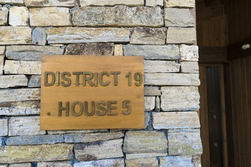 Fototapeta na wymiar Sign for house and district number on stone wall