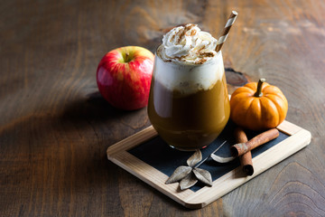 Pumpkin latte with spices, coffee autumn of fall drink with pumpkins, Thanksgiving table, copy space, selective focus