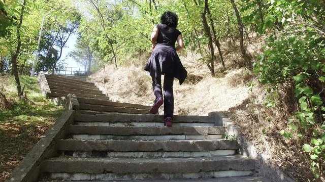 Woman hike over concrete stairs in mountain national park trail