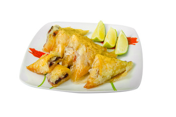 Plate of Homemade baklava with nuts and honey syrup isolated on white, clipping path included