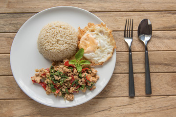 Stir fried chopped pork with chili and basil, served with steamed rice and fried egg,Pad Kra-prao,Thai style food