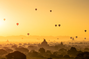 Beautiful sunrise and hot air balloons over ancient pagoda in Bagan is old kingdom in past,...