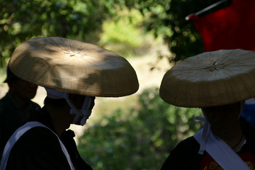 笠を被った男たち