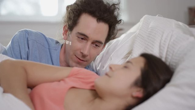 Man trying to instigate affections with his partner in bed but has no success