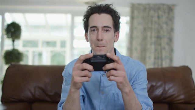  Competitive man playing video games at home, as seen from screen's pov