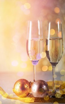 Champagne flutes with Christmas ornaments and ribbon