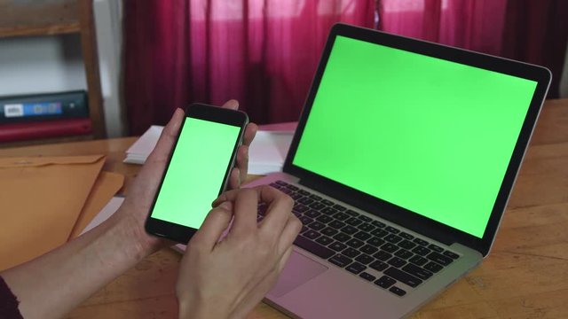  Smartphone green screen with laptop in background