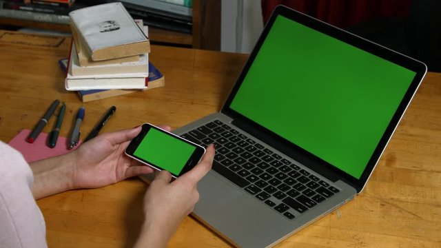  Smartphone green screen with laptop in background