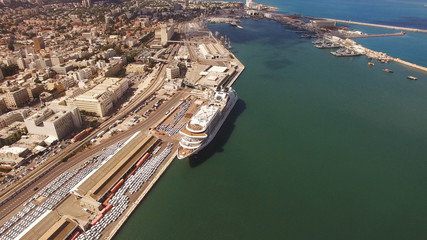 Fototapeta premium Huge large mega ULCV container ship sails on open water fully loaded with containers and cargo - aerial 4k view