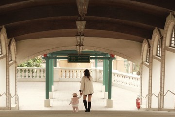 cute little child walking and hand by hand with mommy