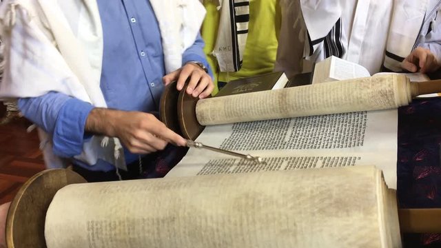 Jewish people reading from the Torah Aliyah Blessings during the High Holidays. Reading the Torah is one of the bases for Jewish life. 
