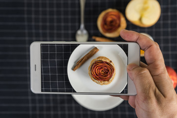 hand holding smartphone take a photo pie apple rose form