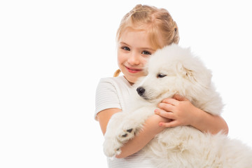 Little girl with a samoyed puppy