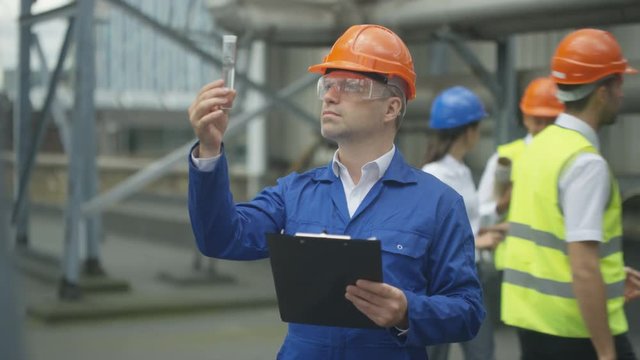 Environmental engineer analyzing a water sample at construction site