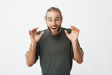 Beautiful swedish guy looking super excited after seeing a cute little kitten and holding hands in...