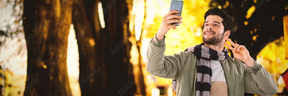 Poster composite image of smiling man taking selfie through mobile