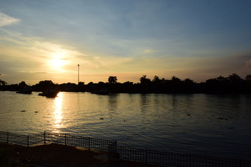 Fototapeta na wymiar The sunset mirroring of the Riverside life 