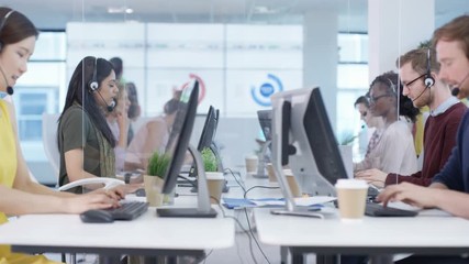 Multiracial telesales team talking to customers in busy call center - Powered by Adobe