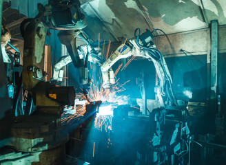 The Welding robots movement in a car factory, manufacturing, industrial

