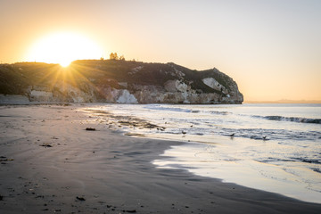 Avila Beach sunrise behind the cliff on the ocean