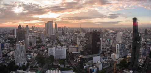Orange Glow From Sunset Over Silom District, Central Bangkok, Thailand, Aerial Panorama Shot