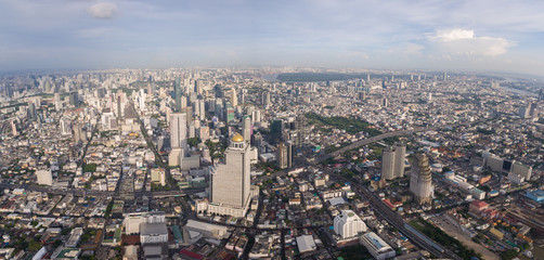 Fototapeta na wymiar Modern Skyscrapers Dominate Bangkok Skyline, Thailand, Aerial Panorama