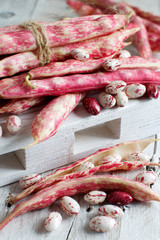 Pinto beans with pods on a wooden table