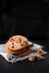 Chocolate chip cookies on dark  with place for text, freshly baked. Selective Focus with Copy space. Heap of  choco cookie.