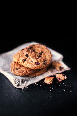 Chocolate chip cookies on dark  with place for text, freshly baked. Selective Focus with Copy space. Heap of  choco cookie.