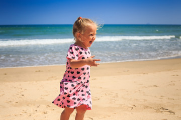 Closeup Little Girl in Pink Cries with Joy by Wave Surf