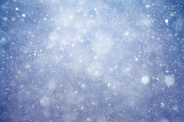 Snowfall texture of snowflakes on blurred background