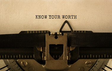Text KNOW YOUR WORTH typed on retro typewriter