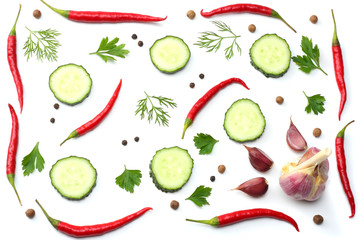 mix red hot chili peppers with parsley and sliced cucumber and garlic isolated on white background top view