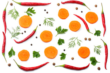 mix red hot chili peppers with parsley and sliced cucumber and carrot isolated on white background top view