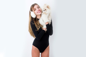 Dog in hand of woman on white background.