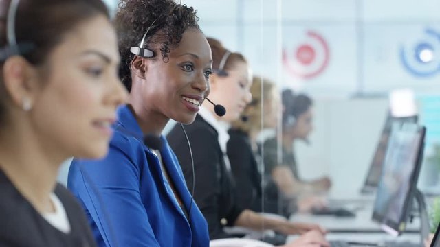  Friendly customer service operators taking calls in busy call center