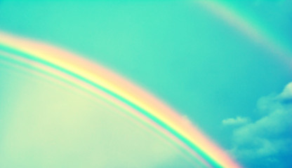 Double rainbow in sky with clouds