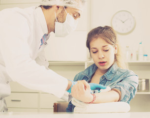 Doctor injecting teenage girl