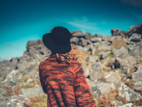 Young woman with hat walking in wilderness