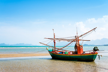Naklejka na ściany i meble fishing boat on the beach