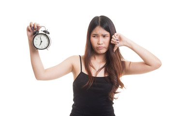 Young Asian woman thumbs down with a clock.