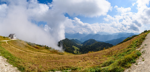 Fototapeta na wymiar panorama view of Mountain peaks in clouds ,view from Mont Hochfelln, Bavarian Alps, Germany