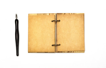 an open notebook with a cover made of natural materials and an old fountain pen