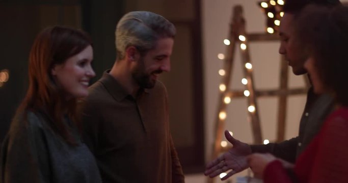 Friends bringing bottle of wine to a party
