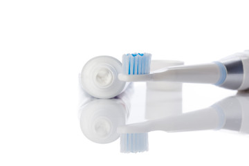 Dental brush and tube with paste isolated on white