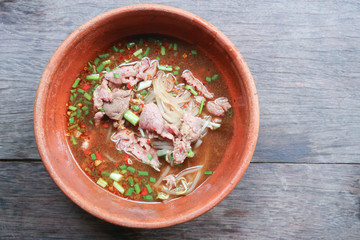 Noodle soup with beef on wood background