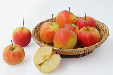 small gala apple in basket over white background