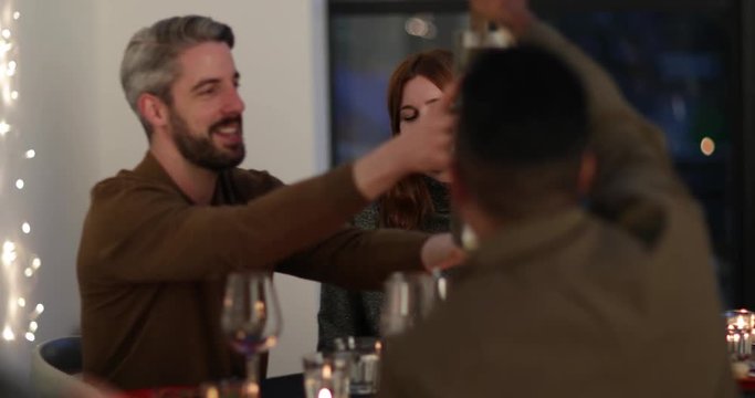 Friends giving a gift of wine at a dinner party