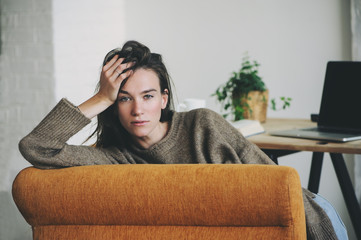 indoor portrait of beautiful feminine thoughtful young women alone in the room.