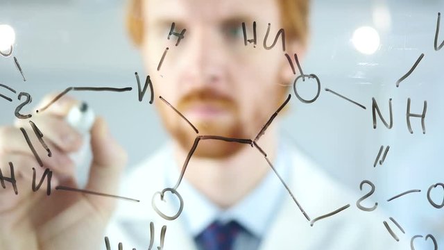 Scientist Writing Chemical Formula on Transparent Glass